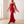 Faustine strapless maxi dress in Red with the sheer scarf trailing as she walks