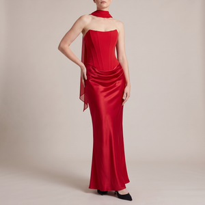 Faustine strapless maxi dress in Red with a sheer scarf on a light gray studio backdrop