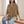 Francesca linen blend button down shirt in Khaki, seated on an oak bench in a bright room