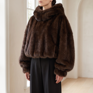 Georgina faux fur hoodie in Brown worn by a window in a bright room