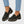 Gloria suede penny loafers in Black worn with cropped jeans