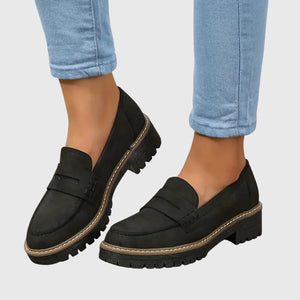 Gloria suede penny loafers in Black worn with cropped jeans