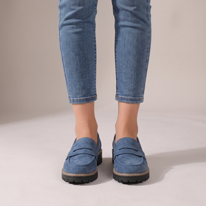 Gloria suede penny loafers in Blue seen from the front on a light gray studio backdrop