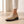 Close view of the penny strap, moc toe and stitched welt on the Gloria suede penny loafers in Beige
