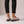 Gloria suede penny loafers in Light Pink seen from behind on a light gray studio backdrop