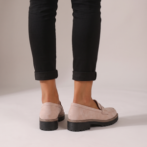 Gloria suede penny loafers in Light Pink seen from behind on a light gray studio backdrop