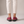 Gloria suede penny loafers in Raspberry seen from behind on a light gray studio backdrop