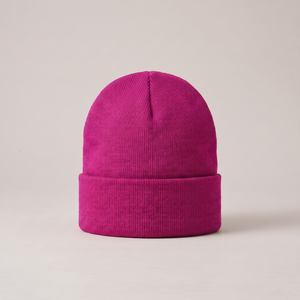 Hattie knit beanie in Magenta with a folded cuff on a light gray studio backdrop