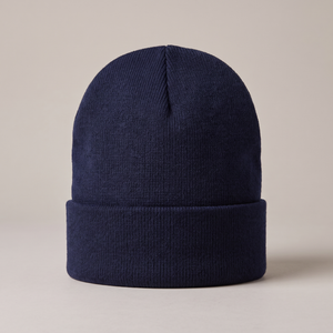 Hattie knit beanie in Navy Blue with a folded cuff on a light gray studio backdrop