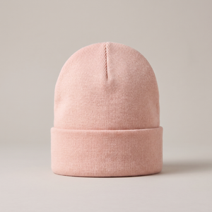 Hattie knit beanie in Pink with a folded cuff on a light gray studio backdrop