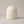 Hattie knit beanie in White with a folded cuff on a light gray studio backdrop