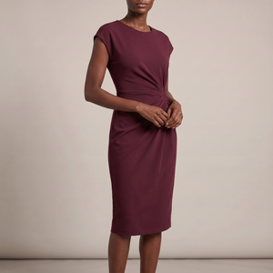 Hester ruched sheath dress in Burgundy on a light gray studio backdrop