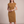 Hester ruched sheath dress in Camel on a light gray studio backdrop