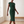 Hester ruched sheath dress in Dark Green, walking across a bright room