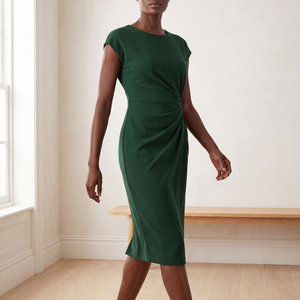 Hester ruched sheath dress in Dark Green, walking across a bright room