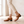 Hortense leather Mary Jane pumps in Cognac, walking on an oak floor