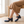Hortense leather Mary Jane pumps in Blue worn seated with a midi skirt