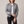Imelda nylon bomber jacket in Gray worn open with one forearm across the waist on a light gray studio backdrop