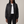 Imelda nylon bomber jacket in Black worn open over a white T shirt on a light gray studio backdrop