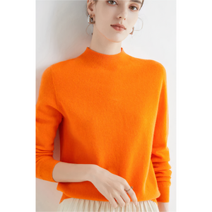Imogen cashmere mock neck sweater in Orange on a model