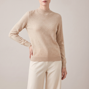 Imogen cashmere mock neck sweater in Beige worn with cream wide leg trousers