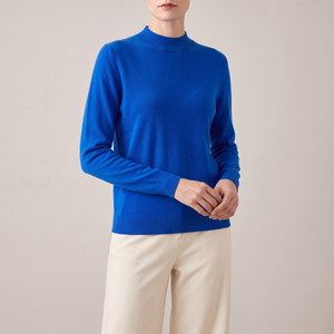 Imogen cashmere mock neck sweater in Blue worn with cream wide leg trousers