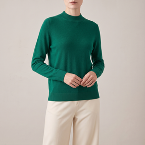 Imogen cashmere mock neck sweater in Green worn with cream wide leg trousers