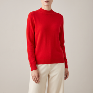 Imogen cashmere mock neck sweater in Red worn with cream wide leg trousers