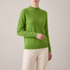Imogen cashmere mock neck sweater in Light Green worn with cream wide leg trousers