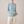 Imogen cashmere mock neck sweater in Sky Blue worn with cream wide leg trousers