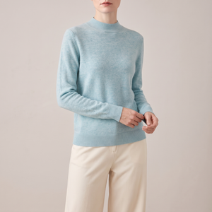 Imogen cashmere mock neck sweater in Sky Blue worn with cream wide leg trousers