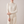 Imogen cashmere mock neck sweater in White worn with cream wide leg trousers