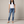 Irene skinny jeans in Blue acid wash with a button fly and rolled cuffs on a light gray studio backdrop