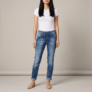 Irene skinny jeans in Blue acid wash with a button fly and rolled cuffs on a light gray studio backdrop