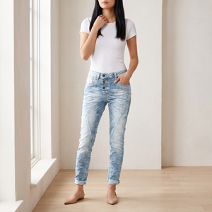Irene skinny jeans in Light Blue worn full length by a window in a bright room