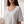 Close view of the scoop neckline and rolled sleeve edge on the Jemima loose scoop neck blouse in Light Gray