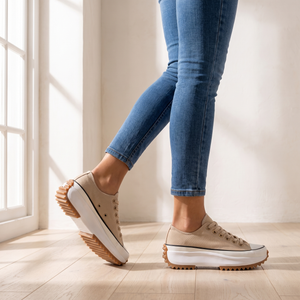 Laetitia canvas platform sneakers in Tan worn mid step by a window