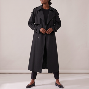 Lillian long trench coat in Black on a light gray studio backdrop