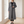 Lillian long trench coat in Gray worn open by a window in a bright room