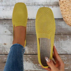 Lorelei slip on flats in Yellow held in hand, showing the insole