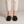 Lorelei slip on flats in Black seen from the front on a light gray studio backdrop