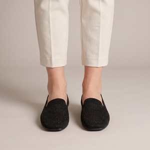 Lorelei slip on flats in Black seen from the front on a light gray studio backdrop