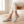 Lorelei slip on flats in Light Gray worn while seated on an oak bench