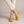 Lorelei slip on flats in Yellow worn with ankles crossed on a light gray studio backdrop