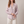 Lucille floral V neck blouse in Pink on a light gray studio backdrop