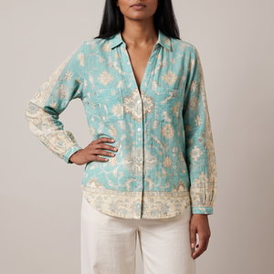 Lucille floral V neck blouse in Turquoise on a light gray studio backdrop