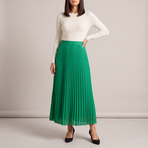 Margot pleated maxi skirt in Green on a light gray studio backdrop