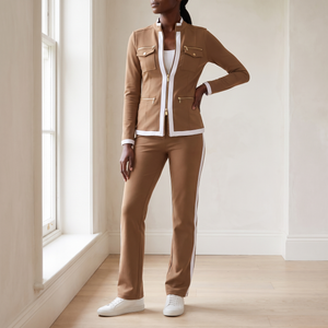 Marianne tracksuit set in Camel worn by a window in a bright room