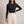 Maribel long sleeve crop top in Black on a light gray studio backdrop