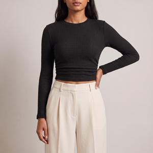 Maribel long sleeve crop top in Black on a light gray studio backdrop